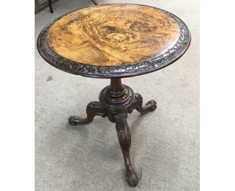 A walnut top occasional table on carved tripod foot.Approx 51x59cm high