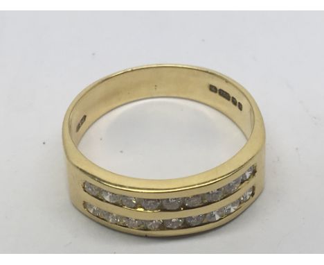 An 18carat yellow gold ring set with two rows of brilliant cut diamonds.ring size O.