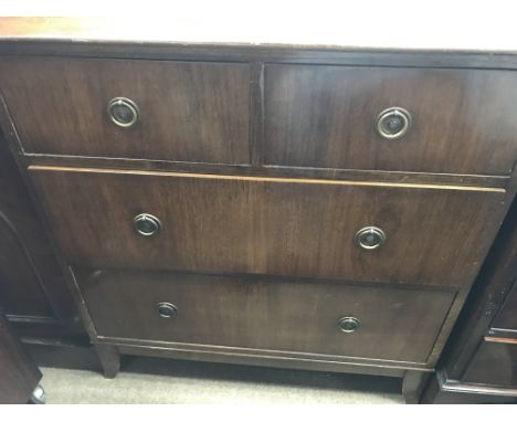 A small mahogany chest of drawers fitted with two short and three long drawers on bracket feet