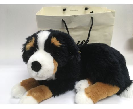 A Steiff Berenese mountain dog with button in ear and Steiff bag.