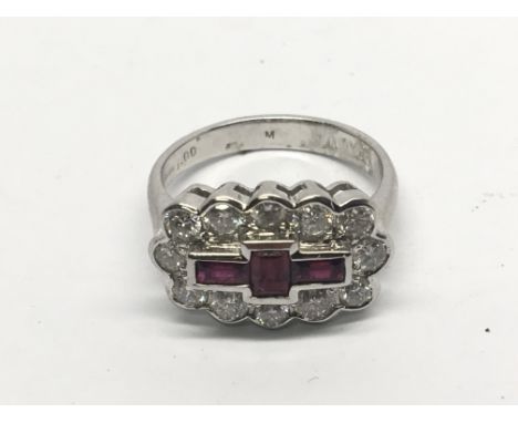 An 18carat white gold modern ring set with a cluster pattern of Ruby’s and diamonds in the form of a cross. Ring size L-M app