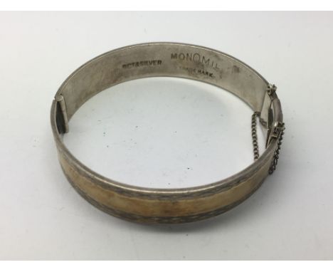 A 9ct gold and silver Monomil bangle, approx 34.3g.