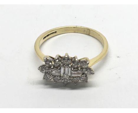 An 18carat yellow  gold ring set with a pattern of baguette and brilliant cut diamonds ring size M-N