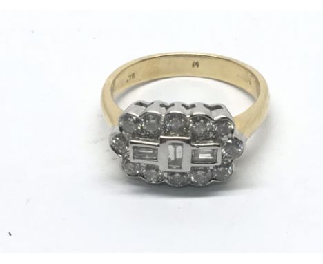 An 18carat yellow gold ring set with baguette diamonds and brilliant cut diamonds. Ring size L-M.