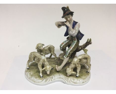 A Continental Porcelain figure group of a Shepherd playing a flute with sheep at foot. Height 8cm - NO RESERVE