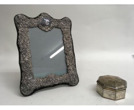 A silver trinket box and silver frame.