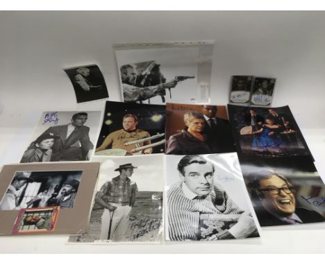 A collection of signed prints including William Shatner, Clint Eastwood, Michael Caine, Charlton Heston and others.