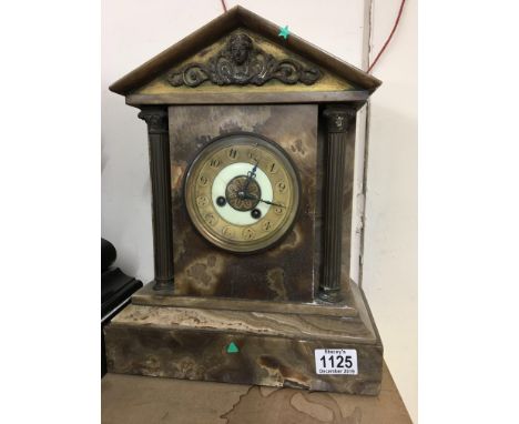 A alabaster clock of classical form the dial with Arabic numerals