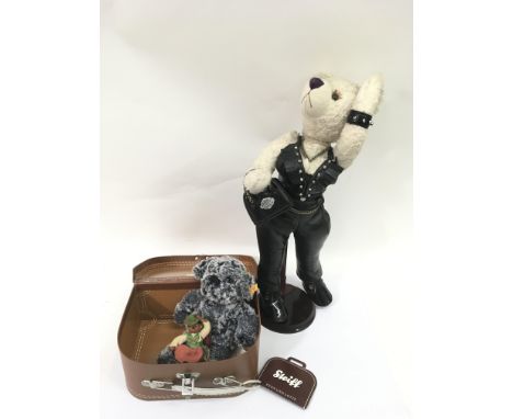 A small Steiff bear in a carry case, hedgehog figure and a motorbiker teddy