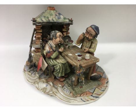 A medium size Capodimonte figural group of a couple playing carsds.Approx 37cm - NO RESERVE