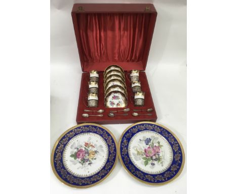 A boxed Spode floral painted and gilded coffee set with silver mounts, plus two similar Limoges plates