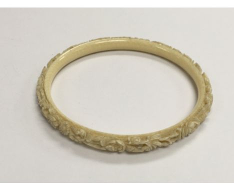 A carved ivory bangle, approx 20g.