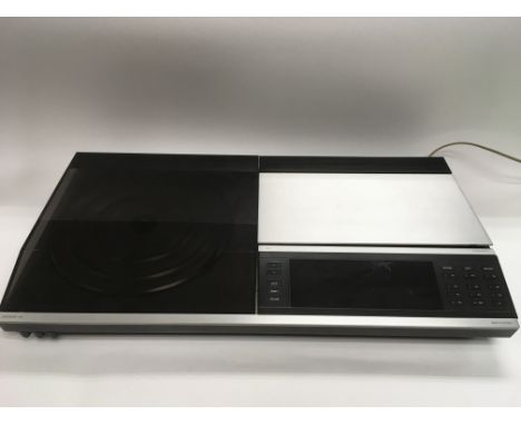 A vintage Bang &amp; Olufsen Beocenter 7007 stereo system and a small collection of records.