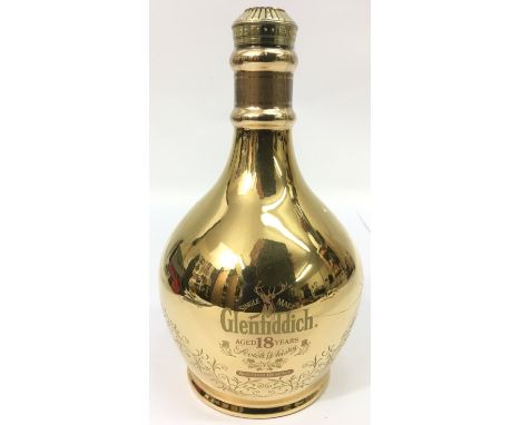 A gold coloured, ceramic bottle of Glenfiddich Scotch Whiskey, aged 18 years, 700ml