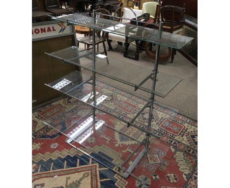 A modern design, vintage ' French Baker' display stand having four glass shelves with chrome fittings.Approx 42cmd x 107cmw x