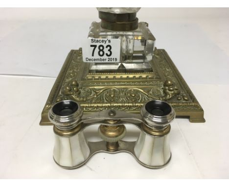 A brass stand inset with a inkwell and a pair of mother of pearl opera glasses