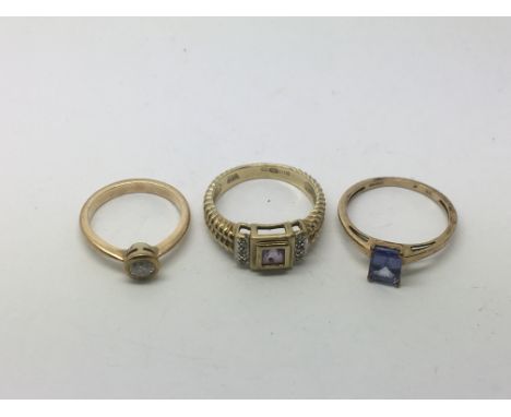 Three rings comprising two 9ct examples and one other unmarked ring, all set with stones, approx 6.6g.
