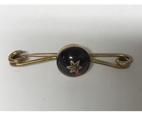 A unmarked Edwardian brooch inset with pigeon blood ruby