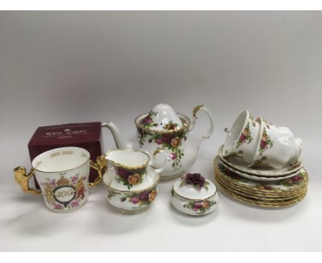A Royal Albert tea service in Old Country Roses, teapot lid damaged, together with a boxed Royal Albert commemorative mug.