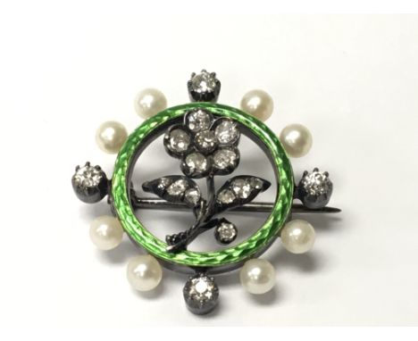 A green enamel brooch set with a floral pattern of old cut diamonds the outer edge with applied pearls and four further diamo