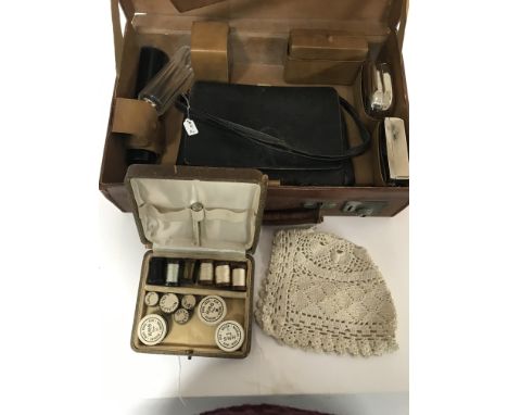 A leather vanity case , a baby's bonnet, a vintage leather handbag and a case of threads and beads