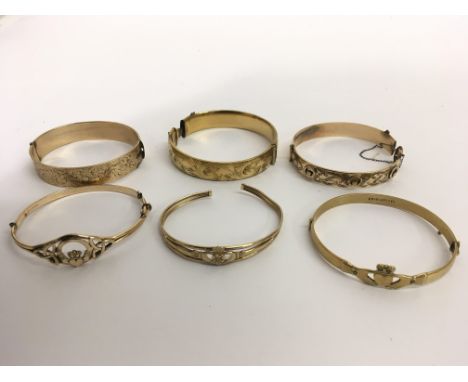 A 9ct gold bangle and five others of rolled or gold core, approx 97g