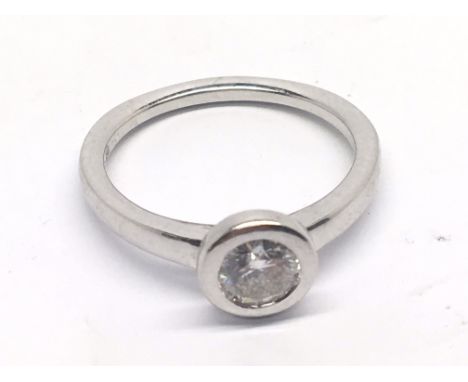 An 18cart white gold modern design ring set with a solitaire diamond 0.52 carat. Ring size M-N