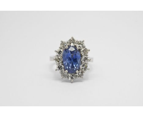 A Quality Sapphire and diamond ring. The central sapphire certified as a natural Ceylon sapphire (with no artificial heat tre