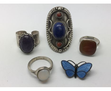 Four silver rings set with stones together with a Norwegian enamel brooch (5).