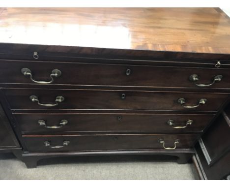 A Georgian mahogany chest of drawers with brushing slide fitted with four drawers on bracket feet .