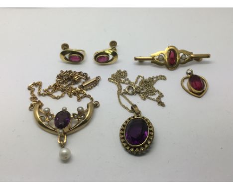 A vintage pearl and amethyst type pendant and chain, a brooch set with a red stone and two pearls together with a matching pe