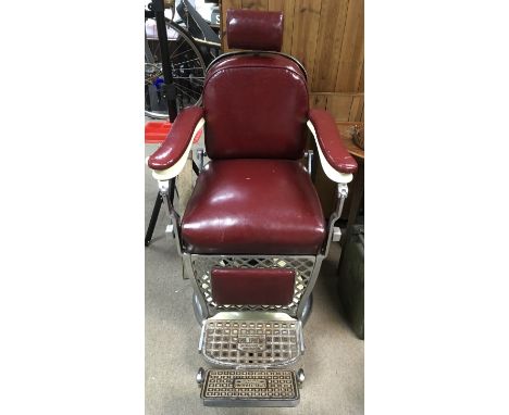 A vintage, Emil Paidar, Chicago, barber's chair, having chrome frame, red faux leather seat on pedestal base with side lever 