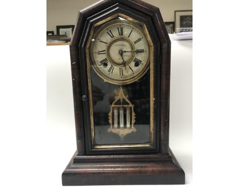 A late 19th century American clock by F. Rombach with key and pendulum.