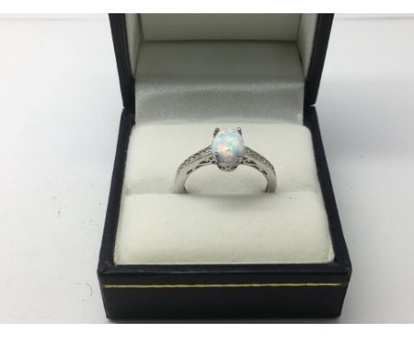 A silver dress ring set with a central Opalite and CZ dress, approx 2.2g and approx size N.