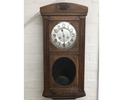 An oak cased 8 day wall clock.