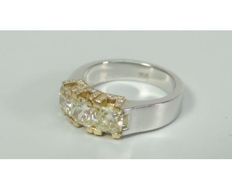 18CT WHITE GOLD THREE STONE YELLOW DIAMOND RING, having further diamond chips to setting. Total diamond weight 1.2ct (visual 