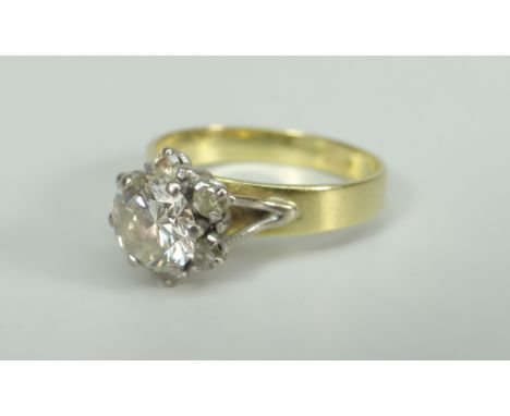 YELLOW METAL DIAMOND FLOWER HEAD CLUSTER RING, the central stone (1.3ct approximate visual estimate) surrounded by six furthe