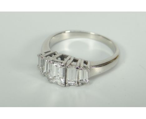 WHITE METAL EMERALD CUT FIVE STONE DIAMOND RING, set with five graduated diamonds. Total diamond weight approximately 1.2 - 1