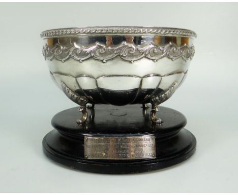 WHITE METAL CIRCULAR BOWL having four scroll feet raised on ebonized plinth, marked P Orr &amp; Sons Ltd, Madras, with presen