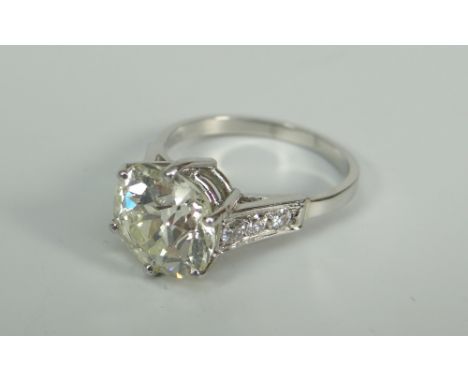 A CUSHION-CUT DIAMOND SOLITAIRE RING visual estimate 4.2ct and estimated as L colour and SI clarity, set in precious white me