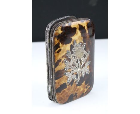 A faux tortoiseshell and leather fitted case with concertina expanding sides and white metal decoration. 