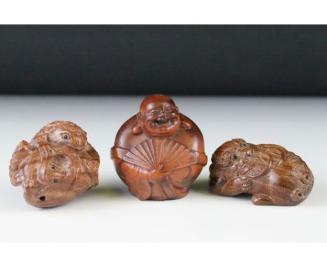 Three carved wood netsuke figures to include toad, happy buddha with fan and money dragon