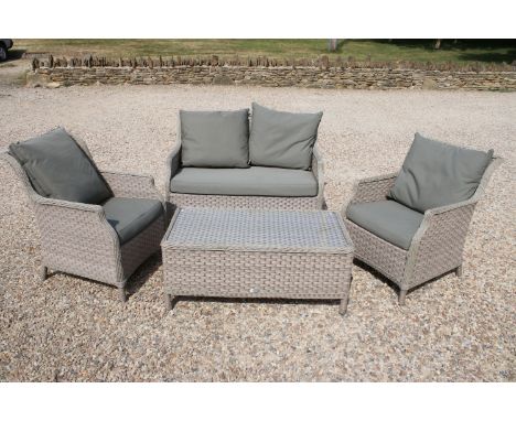 Rattan garden sofa, chairs and table furniture suite. All of woven construction with glass top to table. Sofa measures 121cm 