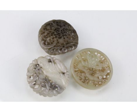 Collection of three Chinese jade carved pendants with Oriental detailing throughout including one pendant with dragon detaili