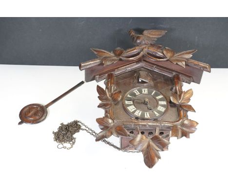 Early 20th Century Black Forest style cuckoo clock, pediment moulded with cuckoo decoration with pendulum, 50cm H