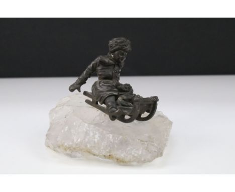 Russian 19th Century Bronze figure of a boy on a sledge on a rock crystal plinth 