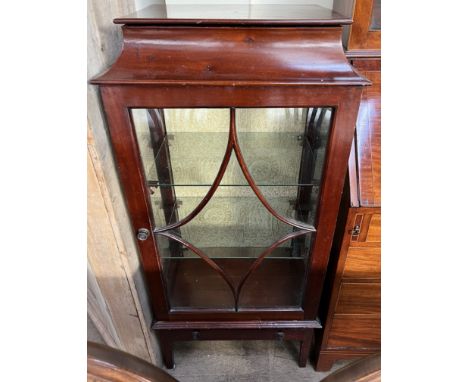 A 20th century mahogany display cabinet with a caddy top above a glazed door and glazed sides and a base drawer on square leg