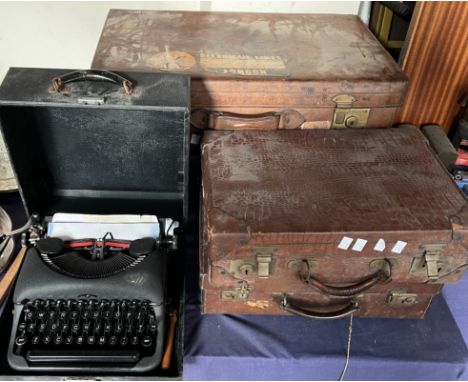 Leather suitcases together with a typewriter