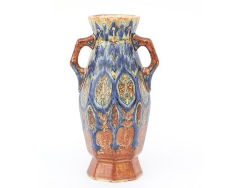 Fayence- en Tegelfabriek Holland, Utrecht An octagonal ceramic vase with two handles, decorated in shades of blue and brown w