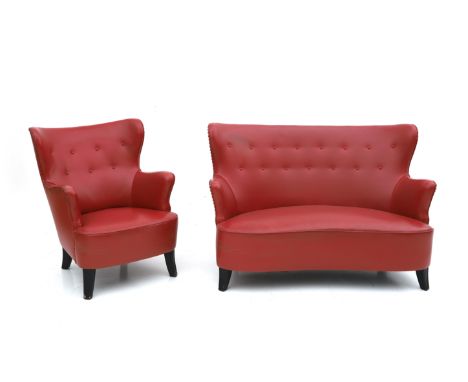 Midcentury Modern A red leatherette upholstered two-seater sofa and an easy chair, the wooden feet ebonised, in the style of 